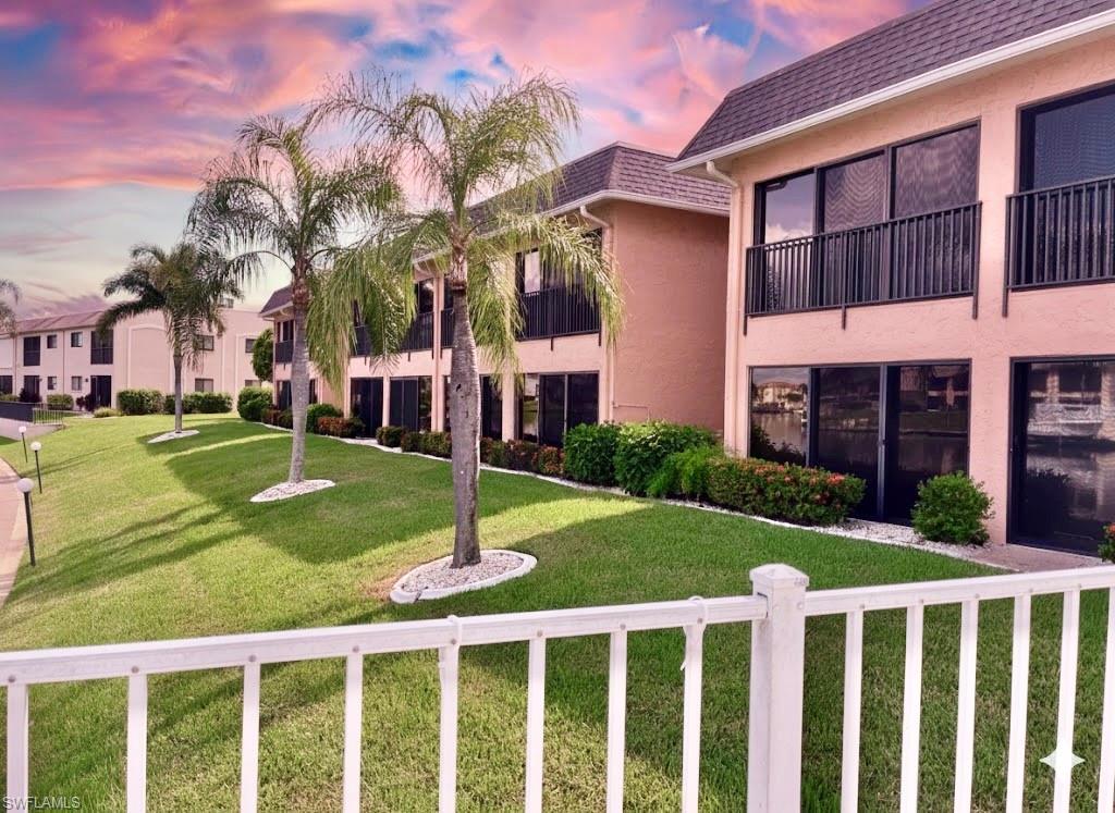 Image 2: View of community with a balcony and a yard