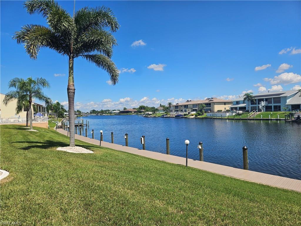 Image 3: Dock area with a lawn, a water view, and a residential view