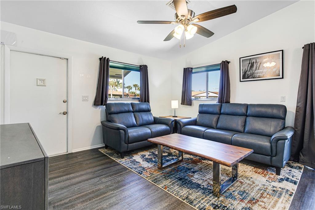 Image 4: Living area featuring vaulted ceiling, dark wood-style floors, and ceiling fan