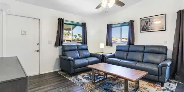 Image 4: Living area featuring vaulted ceiling, dark wood-style floors, and ceiling fan