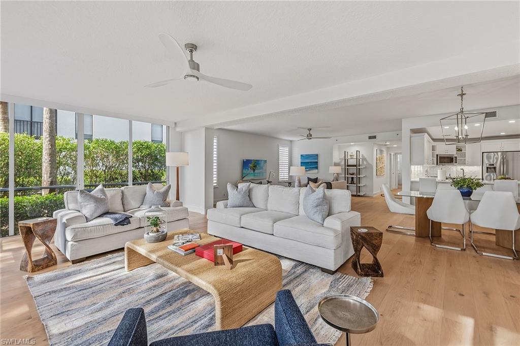 Image 2: Living room featuring light wood-type flooring, ceiling fan, and beamed ceiling