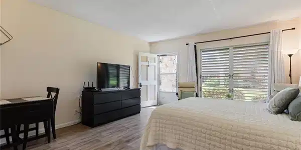 Image 3: Bedroom featuring light wood-style flooring and a textured ceiling