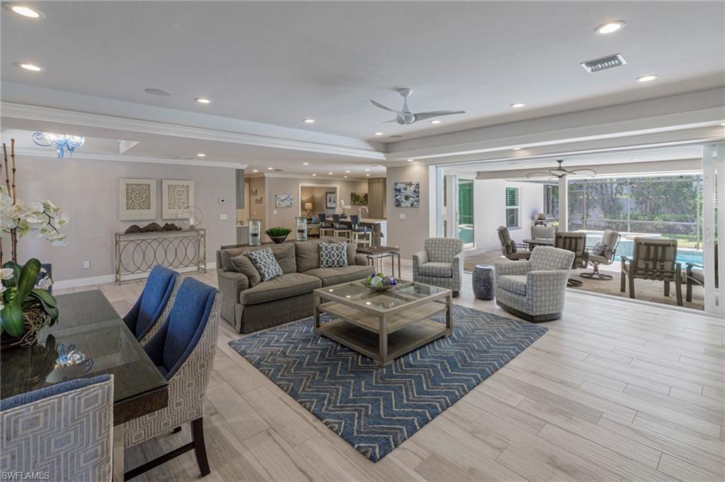 Image 4: Living room with ceiling fan, light hardwood / wood-style flooring, and crown molding