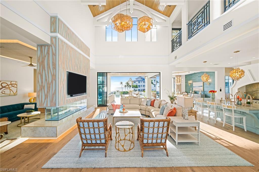 Image 3: Living area featuring a chandelier, light wood finished floors, healthy amount of natural light, and wooden ceiling