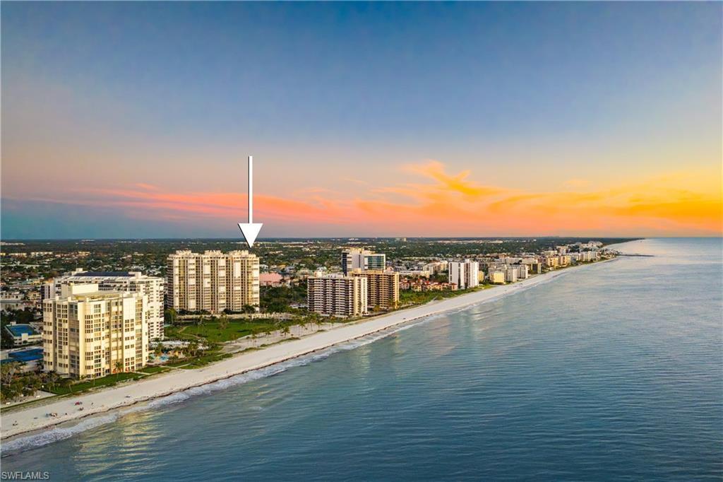 Image 2: Aerial view at dusk of view of water and beach and a view of city