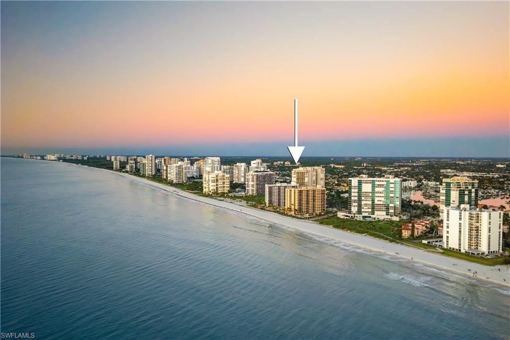 Image 3: Aerial view at dusk of view of water and beach and a view of city