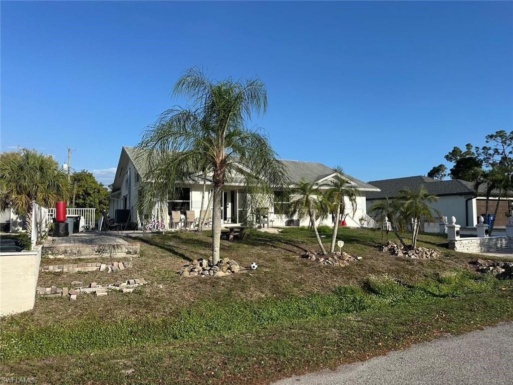 Image 3: Obstructed view of property featuring a front yard