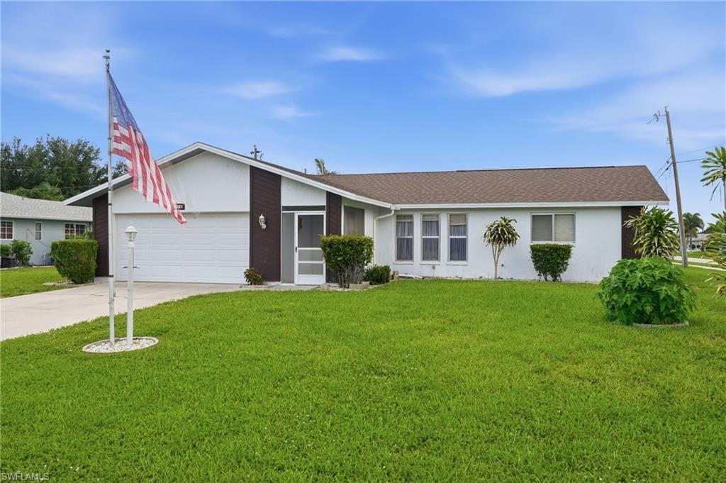 Image 1: Single-story residence featuring a white exterior with brown accents and a dark brown roof