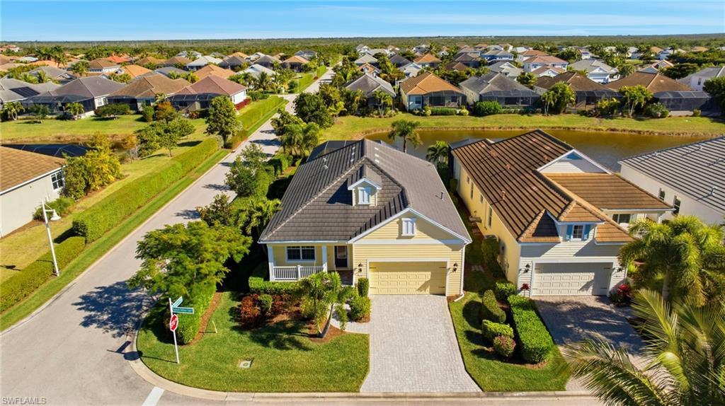Image 3: Aerial perspective of suburban area with a large body of water