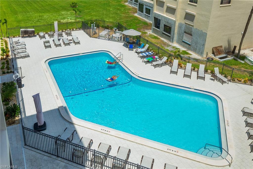 Image 3: Community pool featuring a patio