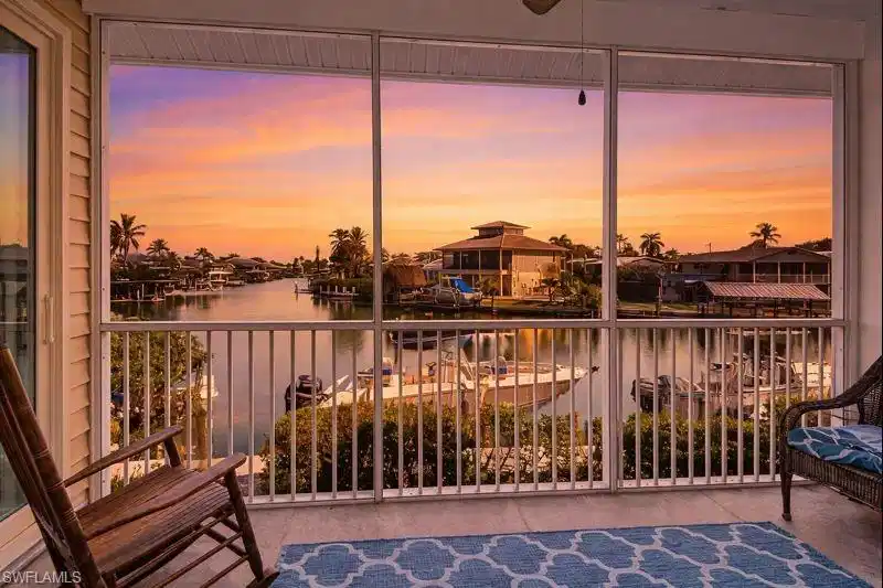 Image 1: Balcony with a water view and a sunroom