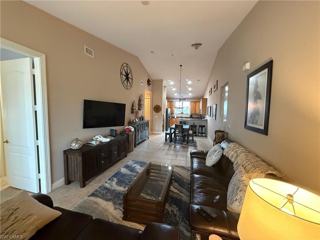 Image 4: Open floor plan. Living and dining area with vaulted ceilings