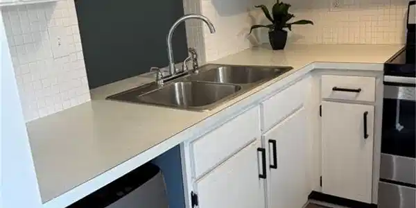Image 2: Kitchen featuring range, light countertops, dishwasher, and backsplash