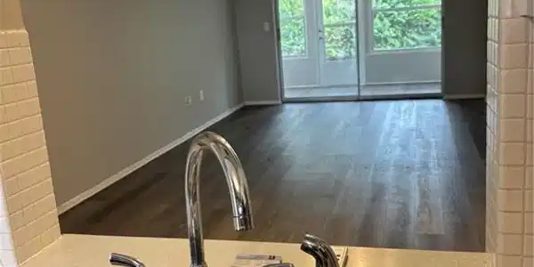 Image 4: Kitchen view of a sink and wood finished floors