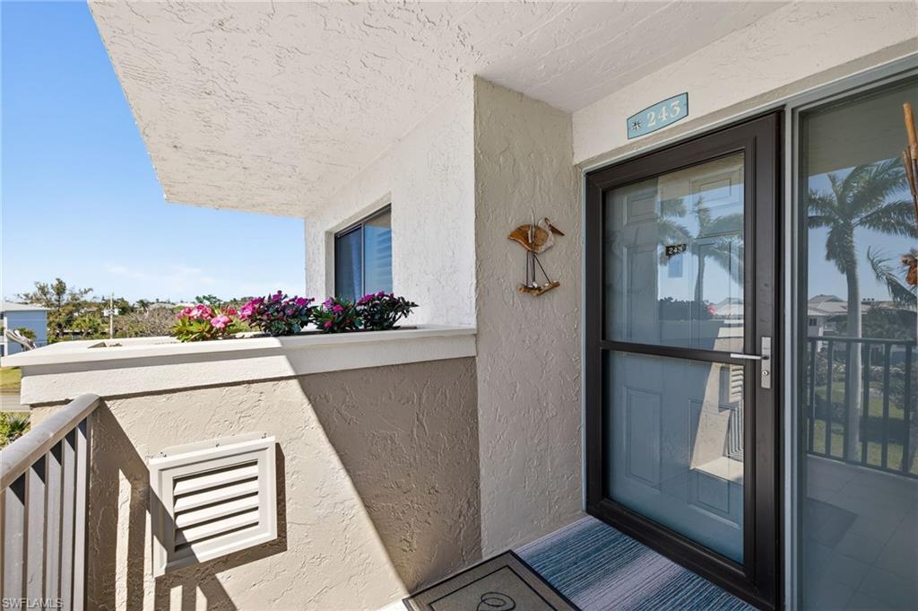 Image 3: Doorway to property featuring stucco siding