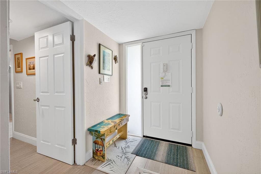 Image 4: Entryway featuring light wood-type flooring and a textured wall