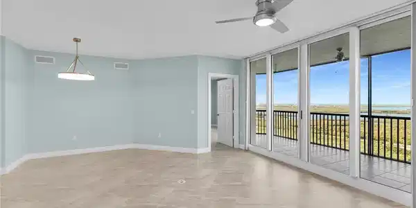 Image 2: Unfurnished room with expansive windows and a ceiling fan
