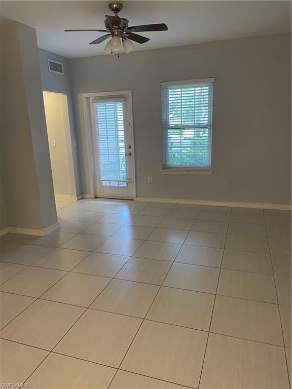 Image 3: Spacious room featuring light-toned tile flooring, neutral wall paint, and a ceiling fan with integrated lighting