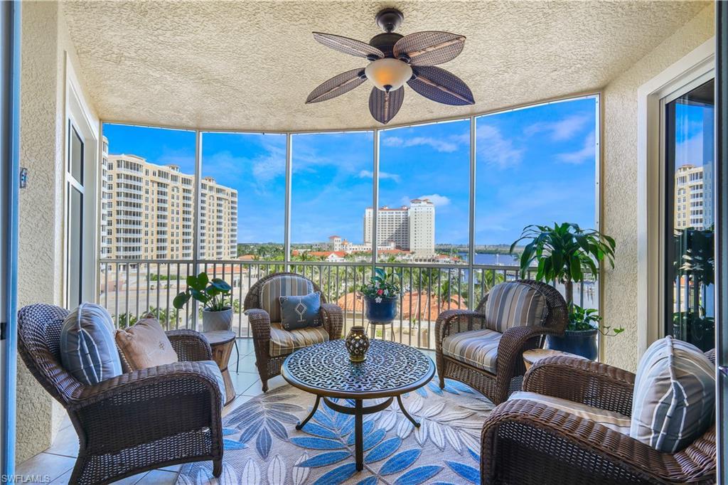 Image 2: Sunroom with a textured wall, expansive windows, a water view, a textured ceiling, and healthy amount of natural light