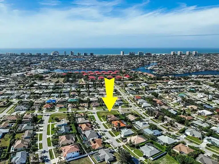 Image 1: Aerial view of property and surrounding area with a nearby body of water and nearby urban area