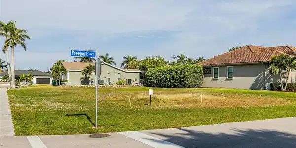 Image 3: View of green lawn with a residential view