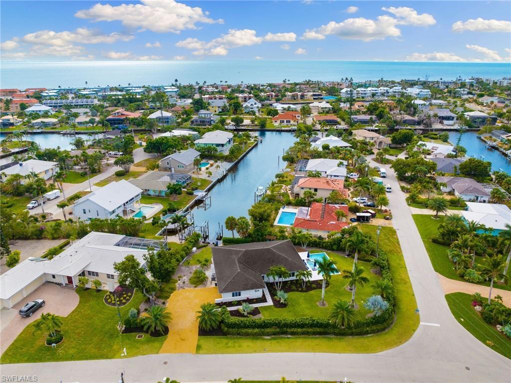 Image 2: Aerial view of residential area with a large body of water