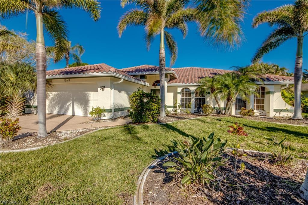 Image 1: Mediterranean / spanish-style house with a garage and a front lawn