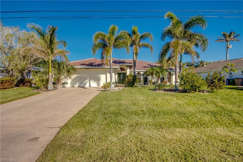 Image 2: View of front of home featuring a garage and a front lawn