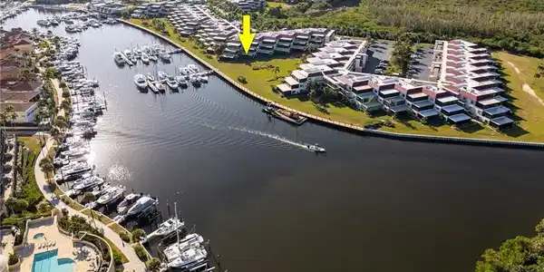 Image 3: Aerial perspective of a waterfront community featuring canal access