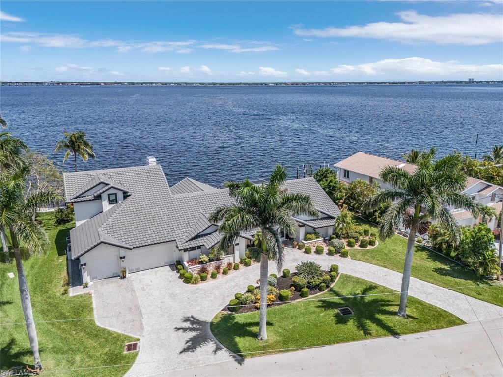 Image 1: Drone / aerial view with a Caloosahatchie River to the East looking across to Ft. Myers with lots of elbow room here....no reach out and touch your neighbor on half acre lot
