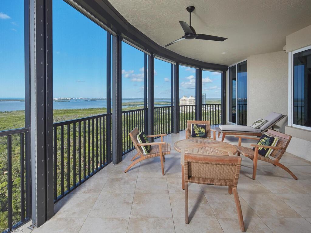 Image 4: Sunroom featuring floor to ceiling windows, a water view, a textured ceiling, and tile patterned flooring