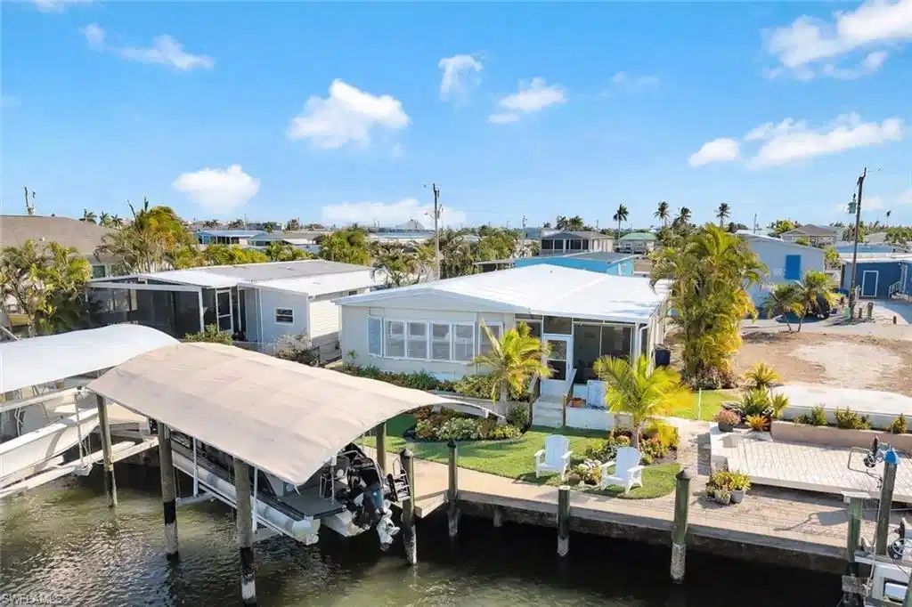 Image 1: Aerial view highlighting the home's waterfront location, private dock, and direct boating access.