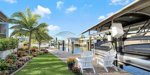 Image 4: Waterfront patio overlooking the canal, creating the perfect space to relax, entertain, and enjoy the Florida boating lifestyle. *AI enhanced