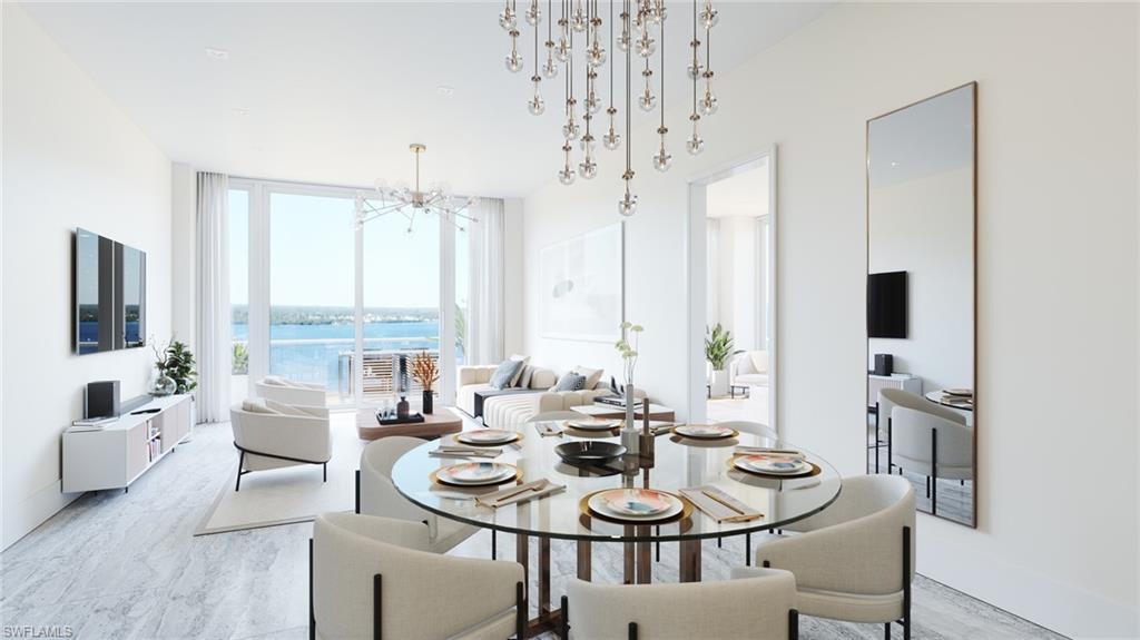 Image 3: Dining area with a notable chandelier and a wall of windows