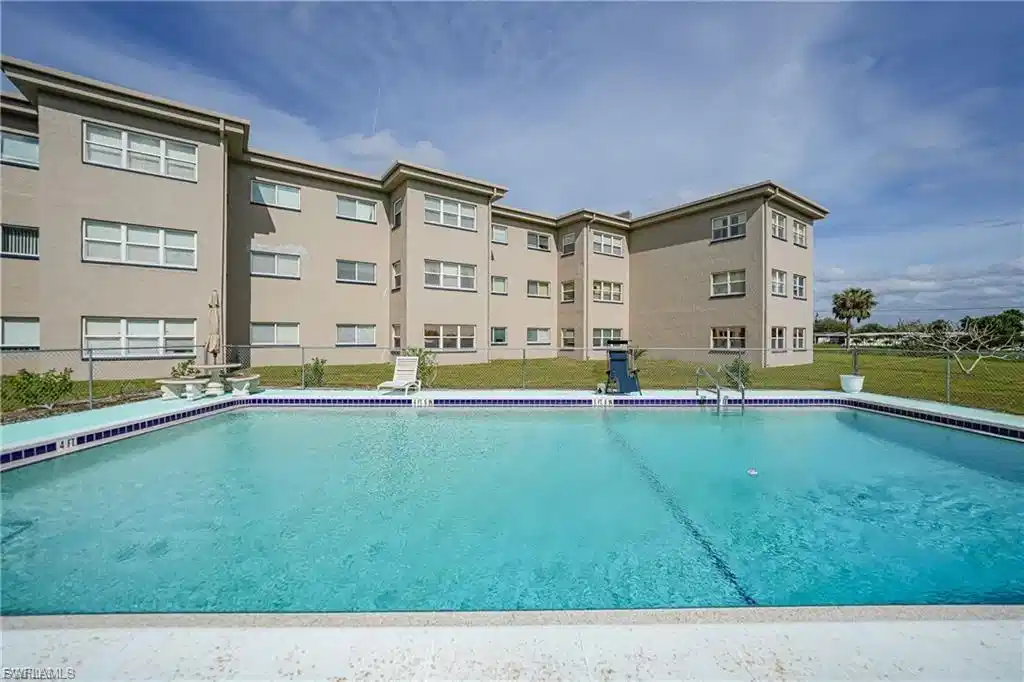Image 1: Community pool with a patio