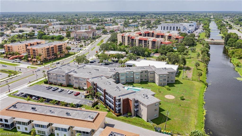 Image 4: Aerial view of a large body of water and apartment complex / building