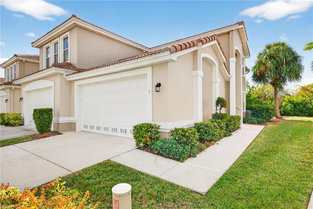 Image 3: View of front of property featuring a front lawn, stucco siding, concrete driveway, and a tiled roof