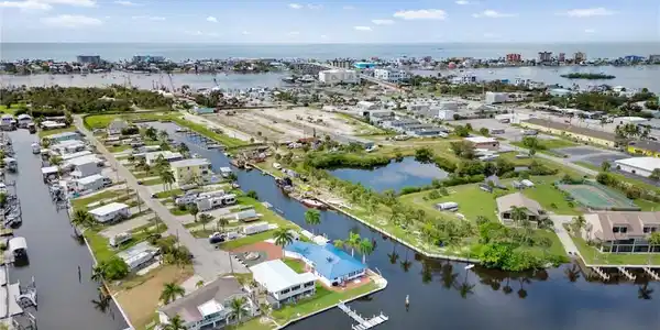 Image 4: Aerial perspective of suburban area with a large body of water