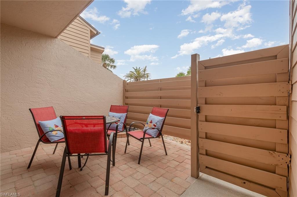 Image 3: View of patio featuring fence and outdoor dining space