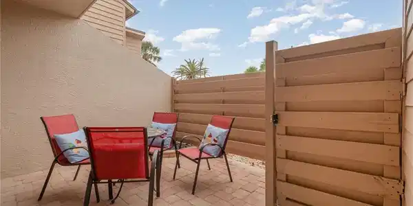 Image 3: View of patio featuring fence and outdoor dining space