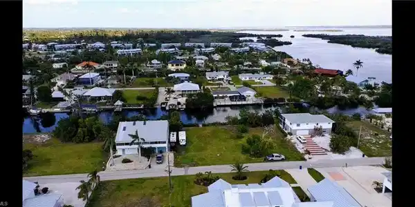 Image 2: Drone / aerial view featuring Charlotte Harbor in the distance.