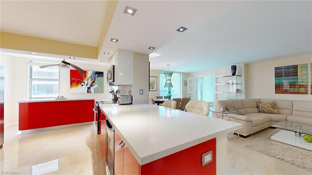 Image 4: Kitchen featuring red cabinets, open floor plan, healthy amount of natural light, stainless steel appliances, and recessed lighting