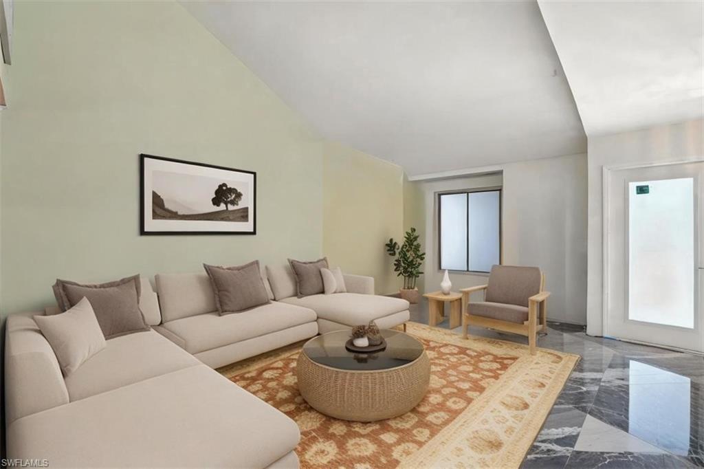 Image 4: Living area featuring vaulted ceiling and marble finish floors - Virtually Staged and Edited Image