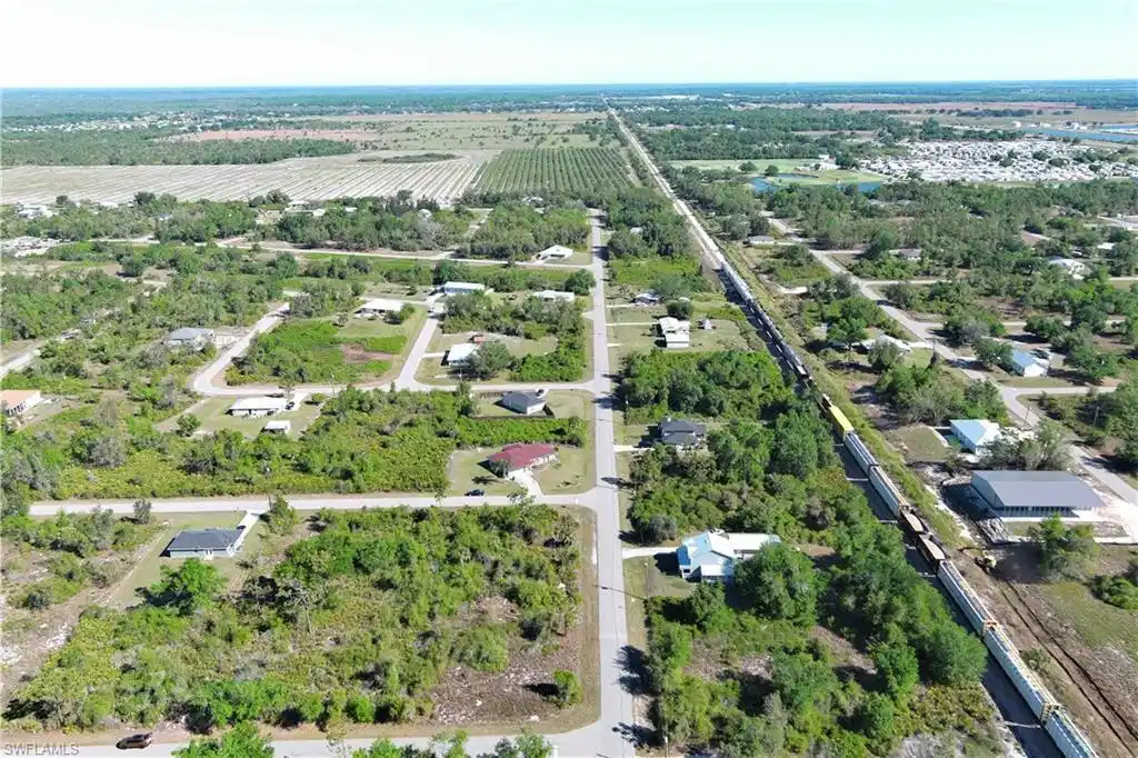 Image 1: Aerial overview of property's location featuring extensive farmland and rural landscape