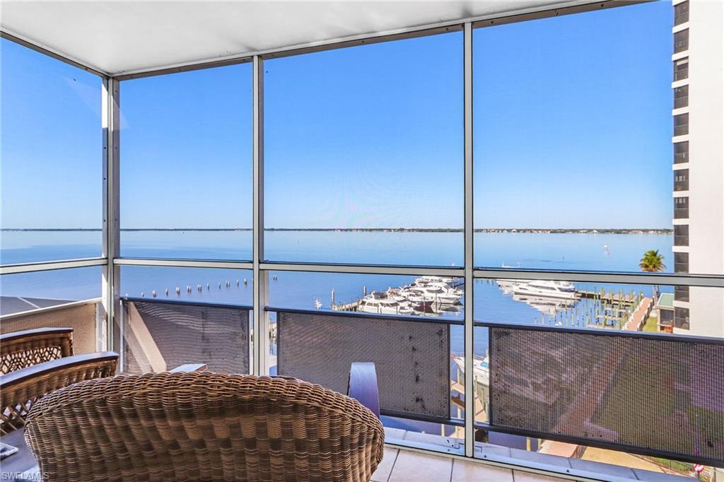 Image 2: Sunroom featuring view of marina and a water view