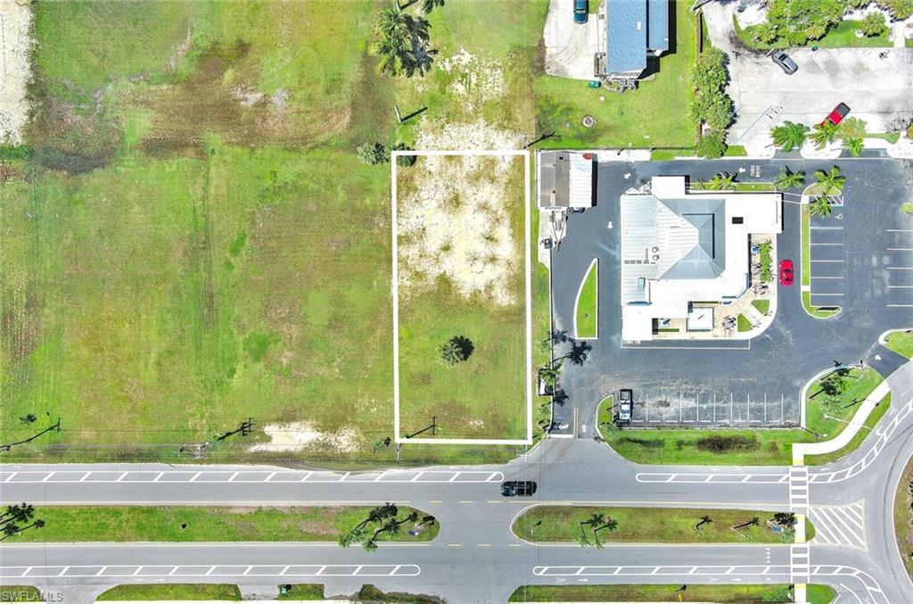 Image 2: Aerial view of property and surrounding area with property parcel outlined