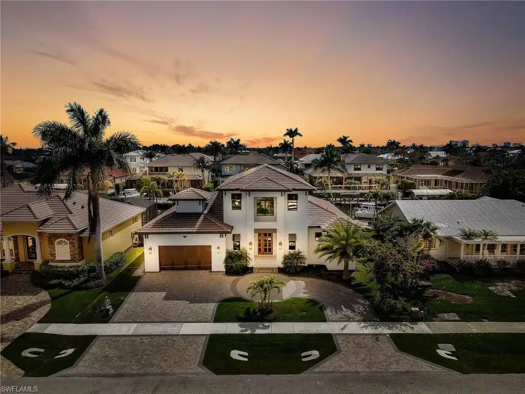 Image 1: View of front of property with decorative driveway, a residential view, stucco siding, and a tiled roof