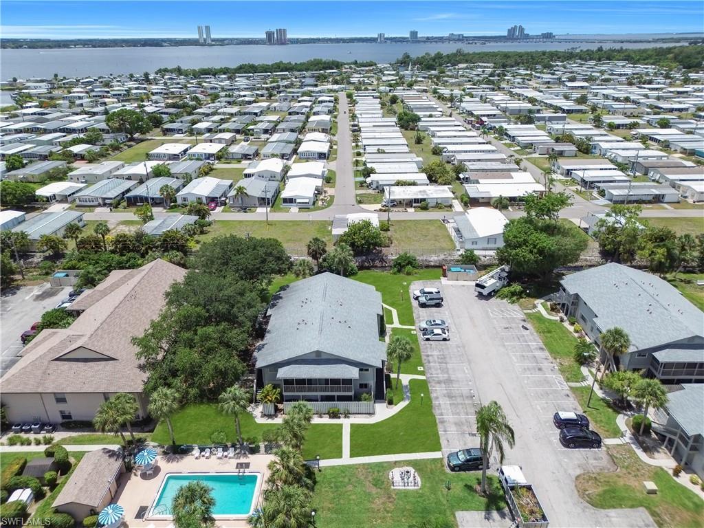 Image 4: Aerial perspective featuring a residential community with numerous single-story properties and multi-unit buildings