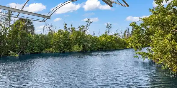 Image 3: BEAUTIFULLY UPDATED, MOVE-IN-READY waterfront home offers the perfect combination of COASTAL CHARM, BOATING CONVENIENCE & RESORT-STYLE LIVING
