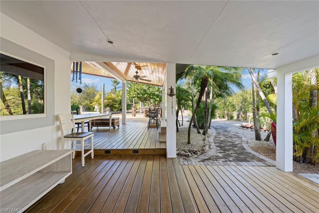 Image 2: Wooden terrace with outdoor dining space and a ceiling fan